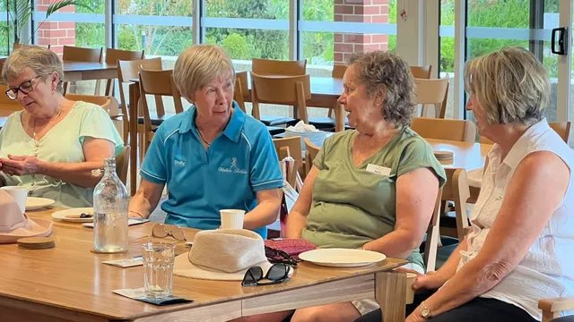 Clients and support workers sitting together around a table