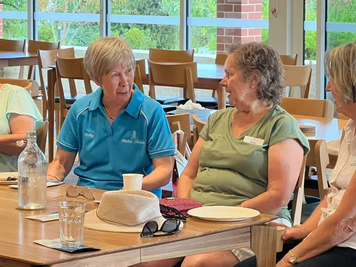Sewa Care clients and support workers sitting together around a table
