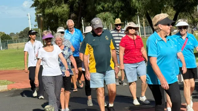 A group walking together outdoors in Sewa Care shirts