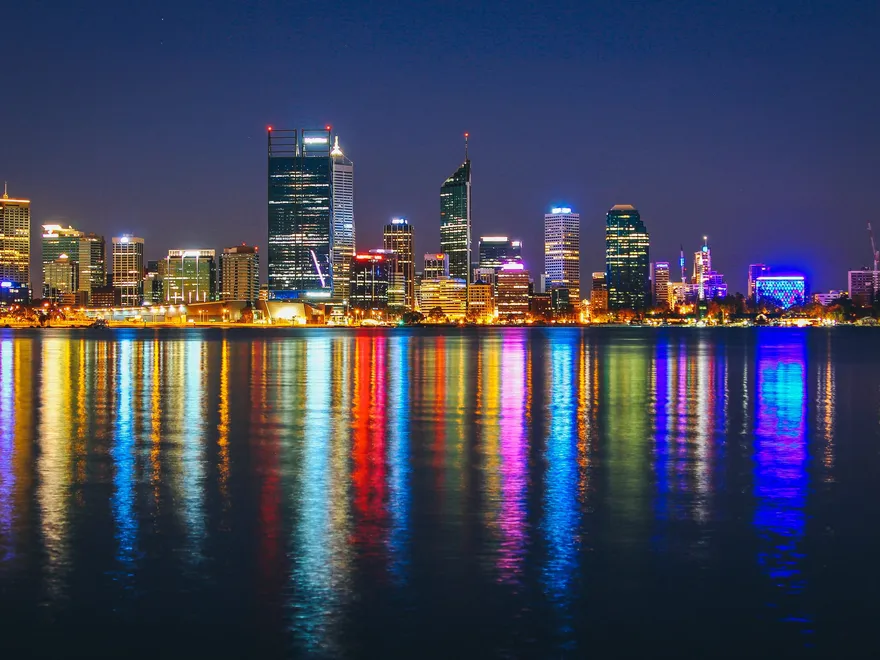 The Perth skyline at night reflected across the Swan River