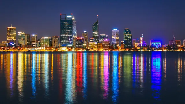The Perth skyline at night reflected across the Swan River